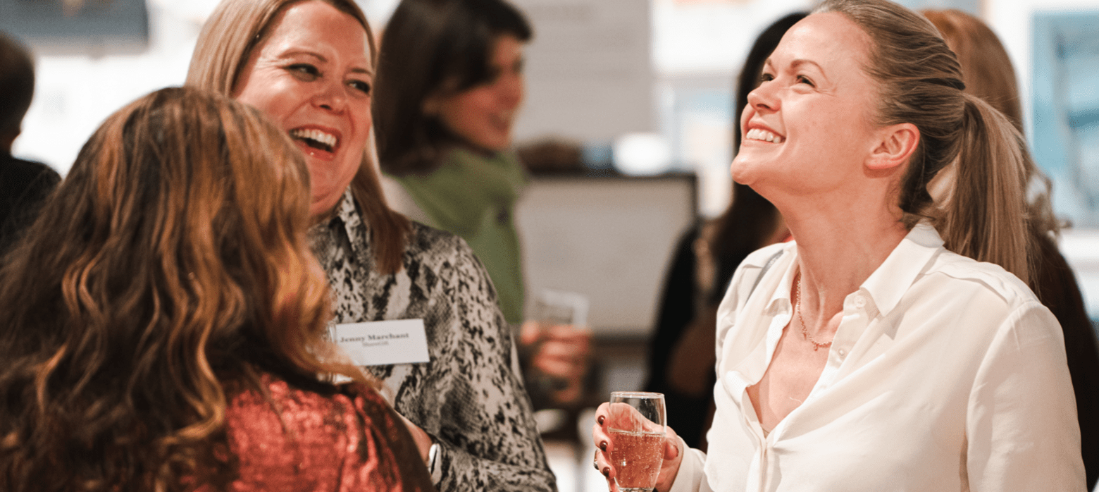 3 women gathered in the west gallery laughing and enjoying drinks