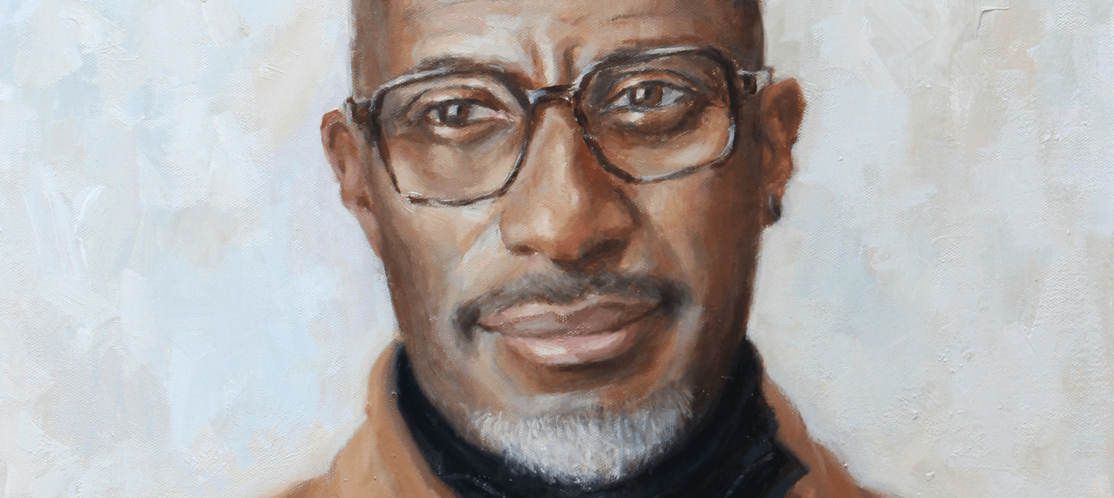 Portrait of Clint Dyer in a brown shirt and black turtleneck