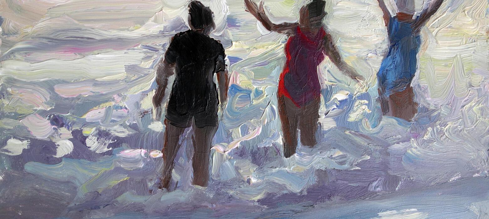 3 figures in swimming costumes standing in the ocean