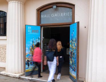 Image of people walking through gallery entrance