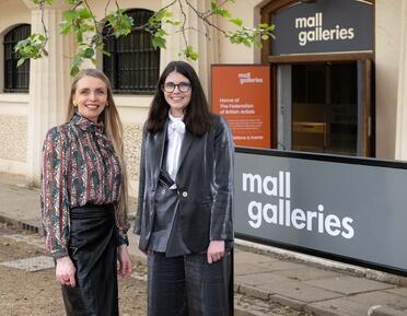 Photo of two people outside of Mall Galleries