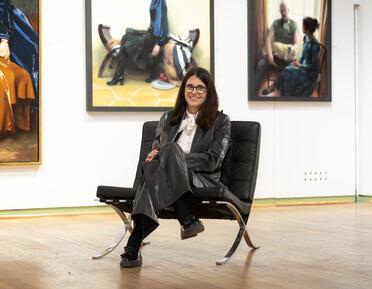 Photo of woman sat on a chair during the RP exhibition