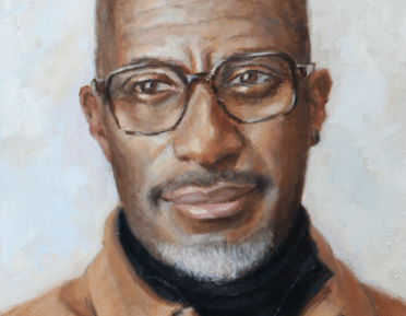 Portrait of Clint Dyer in a brown shirt and black turtleneck